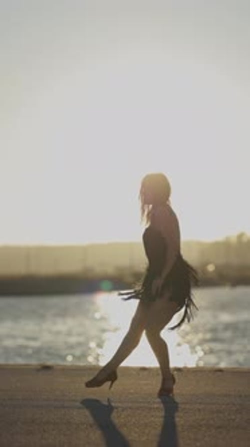 Woman Performing Latin Dance Routine at Sunset