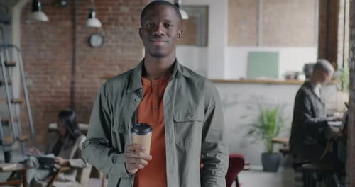 Slow Motion Portrait of Cheerful African American Entrepreneur Standing in Cafe Holding Coffee Cup