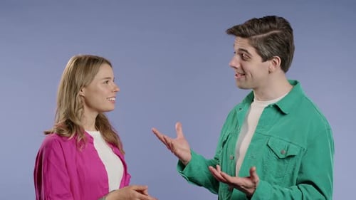 Young Woman and Man Talking and Gesturing in Studio