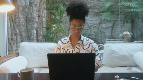 Female Freelancer Working on Laptop at Workplace in Home Office