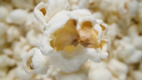 Imitation of a fall, concept. Popcorn falls down into a pile of other popcorn. Extreme macro zoom. S