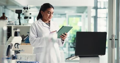 Woman in Lab Using Tablet in Workplace
