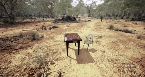 Deserted Table and Chair in Arid Landscape Under Bright Sunlight