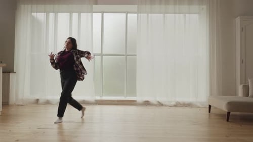 Woman Dances in a Sunny Room