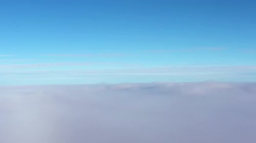 Blue sky background above mist, gradiently turning into a fog background