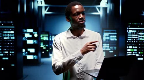Engineer Walking Between Supercomputers