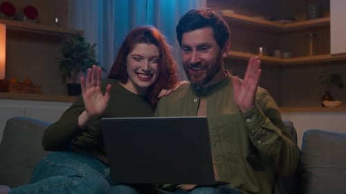 Happy Couple Video Calling at Home on Couch