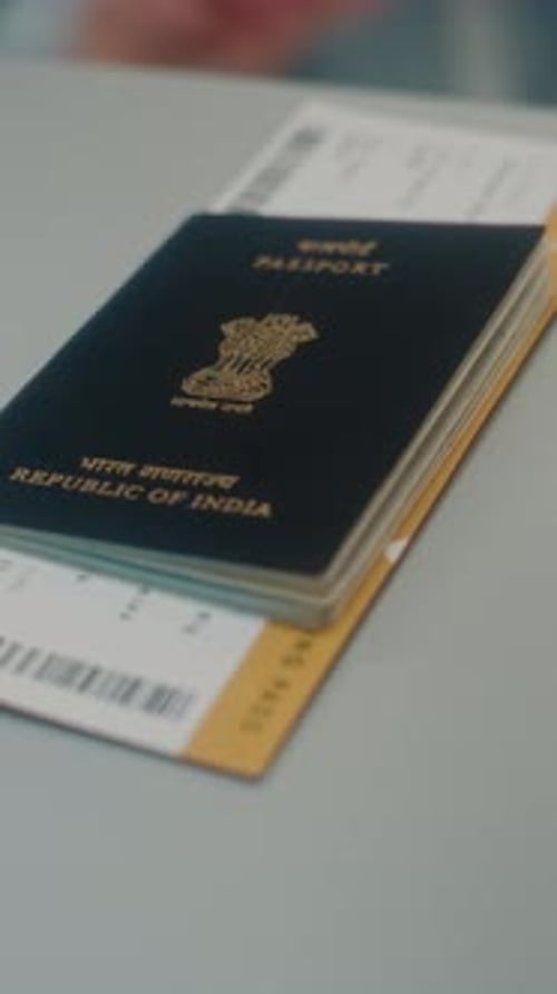 Airport Terminal Close Up of Tourist Putting Indian Passport with Flight Ticket on Counter