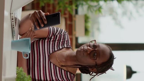 Vertical Video Freelancer Using Online Videoconference Call to Talk to Colleagues