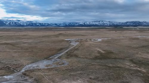 RV Campers at Remote Hot Springs Beneath Mountains