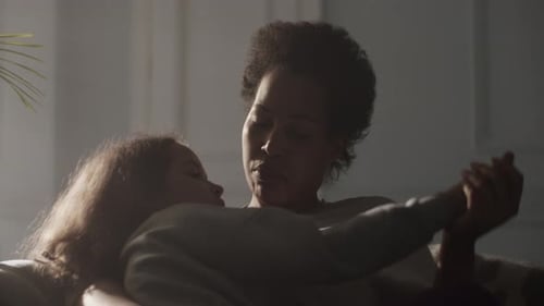 Woman and Child Holding Hands Indoors