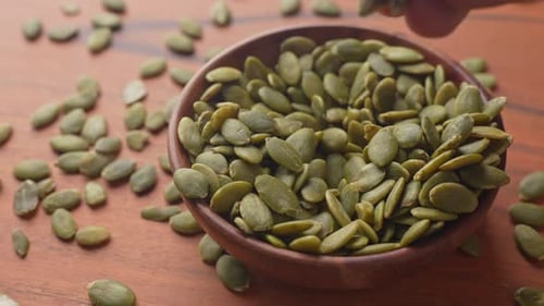 Healthy Toasted Green Pumpkin Seeds Served in a Wooden Bowl