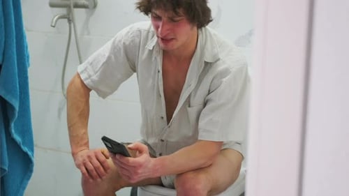 Joyful Restroom Selfie Laughing Man Using Toilet Phone Relaxed Individual Enjoying Humorous Moment