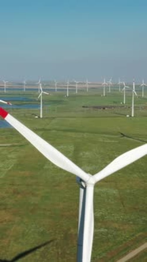 Aerial view of windmills on wind farm in rotation