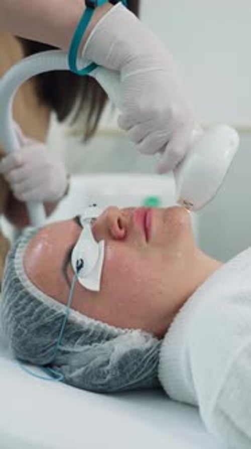 Woman Receives Facial Treatment in Beauty Clinic