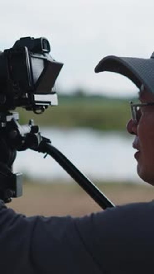 a Professional Photographer Turns the Focus Ring of His Photographic Lens Before Photographing