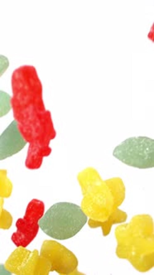 Colorful Gummy Candies Falling Against White Background