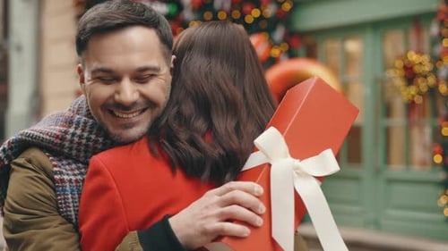 A Joyful Couple in Love Standing on the Winter Street Celebrates Valentine's Day with Romance The