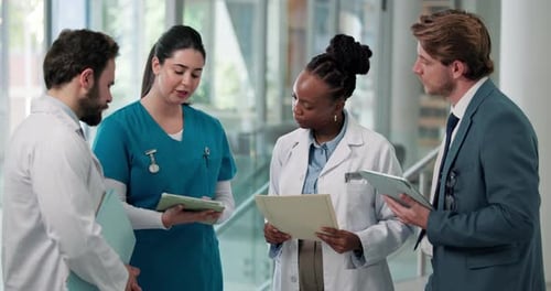 Tablet, meeting and team of doctors and nurses in hospital for medical diagnosis in collaboration