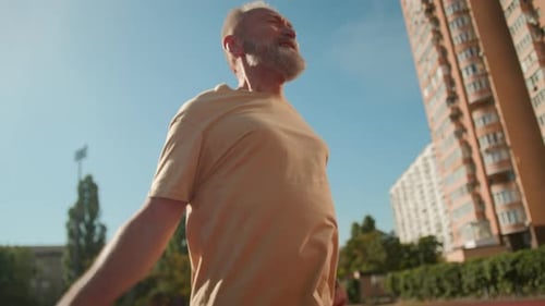 Senior Man Skipping Rope at Outdoor Track