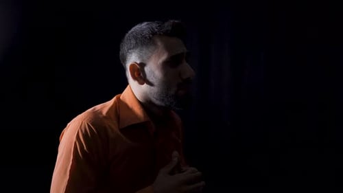 Distressed Man Talking Frantically in the Dark