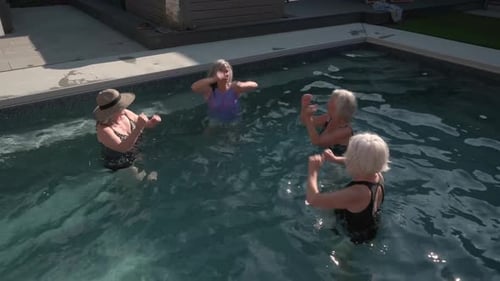 Energetic Senior Women Dancing Doing Water Aerobics in Sunny Summer Swimming Pool Active Seniors