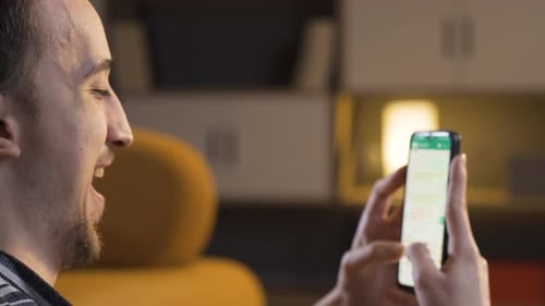 Young Adult Using Smartphone for Communication Indoors