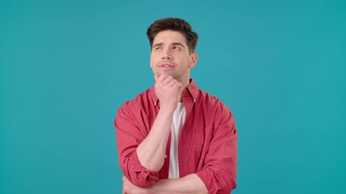 Young Man Thinking Deeply on Blue Background
