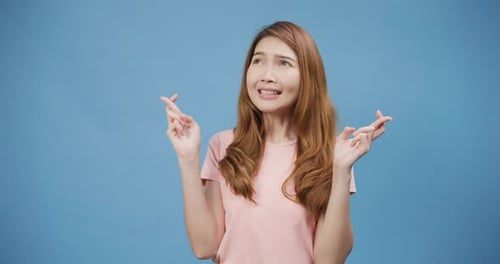 Excited Woman Celebrates Big Win Against Blue Background
