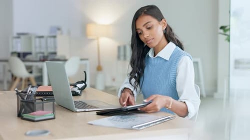 Young Woman Works at Desk with Laptop and Tablet