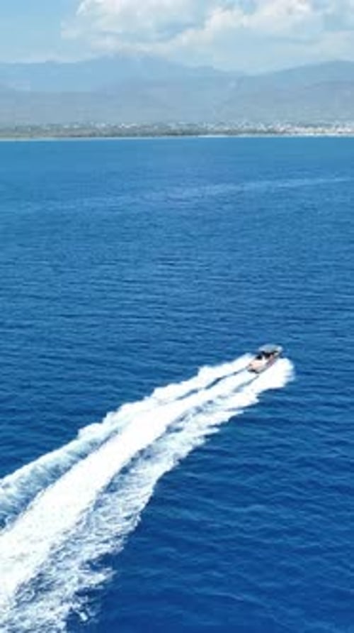 Speedboat Glides on Blue Ocean Waters Aerial View