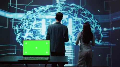 Teamworking AI Technicians Using Green Screen Laptop for Business Data Analysis
