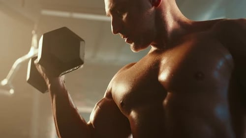Man Lifting Dumbbell During Intense Gym Workout