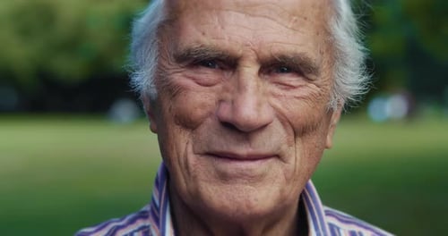 Portrait of Senior Man Looking at Camera in Park