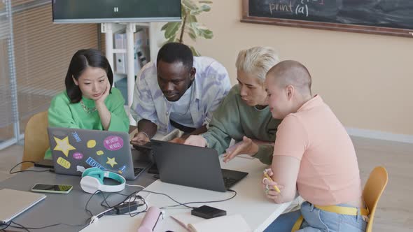 Gen Z Students Coding on Laptop Together in College Classroom ...