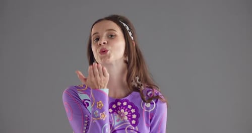 Studio, woman and face with air kiss for blowing, romance and emoji gesture with expression