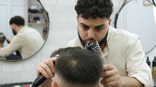 Hairdresser Styling Men's Hair in a Salon