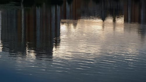 Water Reflecting Cityscape Buildings Drone . Calm Wavy River Flowing Surface. Abstract
