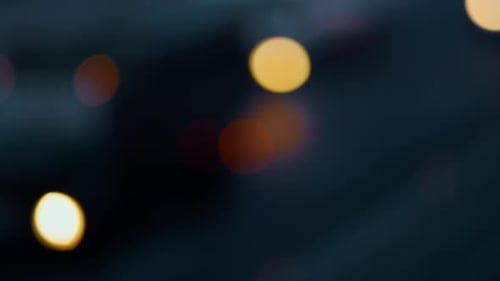 Evening highway bokeh city traffic rush blurred yellow headlights moving vehicles