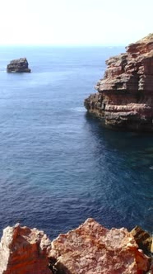 Stunning Aerial Capture Showcasing Jagged Sea Stacks with Crashing Waves and Eroded Shores