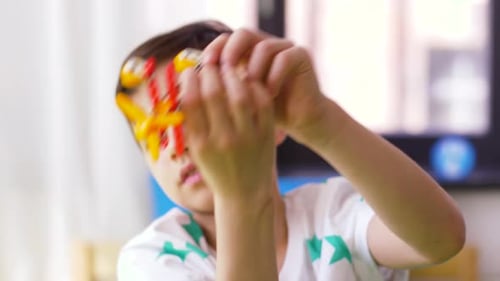 Young Boy Plays with Toy Plane Indoors