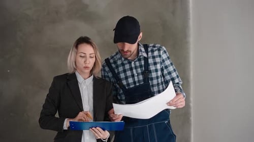 Reviewing Construction Plans Together in Undecorated Building