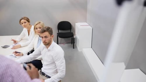 Teamwork And Corporate Concept - Business People With Papers At Presentation Or Team Building Eve...