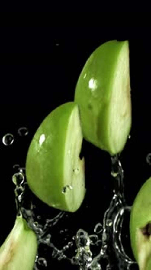Pieces of Green Apples Fly Up and Fall Down Filmed on a Highspeed Camera at 1000 Fps
