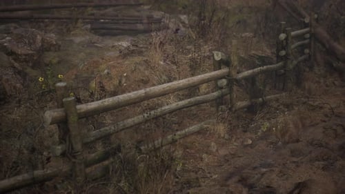 An Old Wood Fence with a Country Field Behind It