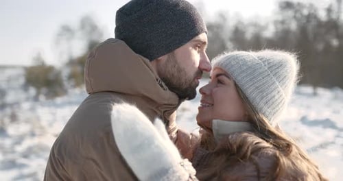 Couple in Love Cuddling in Winter Forest