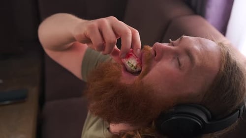 Red Bearded hipster putting delicious sushi rolls in mouth throwing my head back and closing eyes