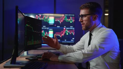 Trader Working With Stocks At Night In Office