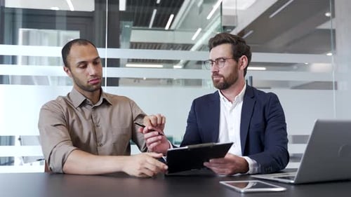Businessman exchanging handshake with male client after signing contract, partner deal or employment