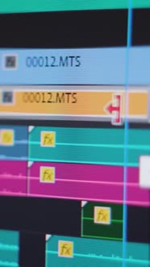 Video editing. Moving and trimming a video clip on a complex timeline. Screen close up